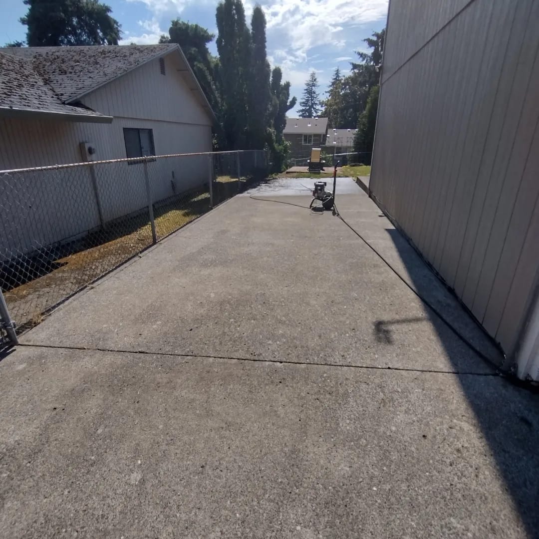 A concrete driveway after a Curb Appeal pressure wash, clean and dry