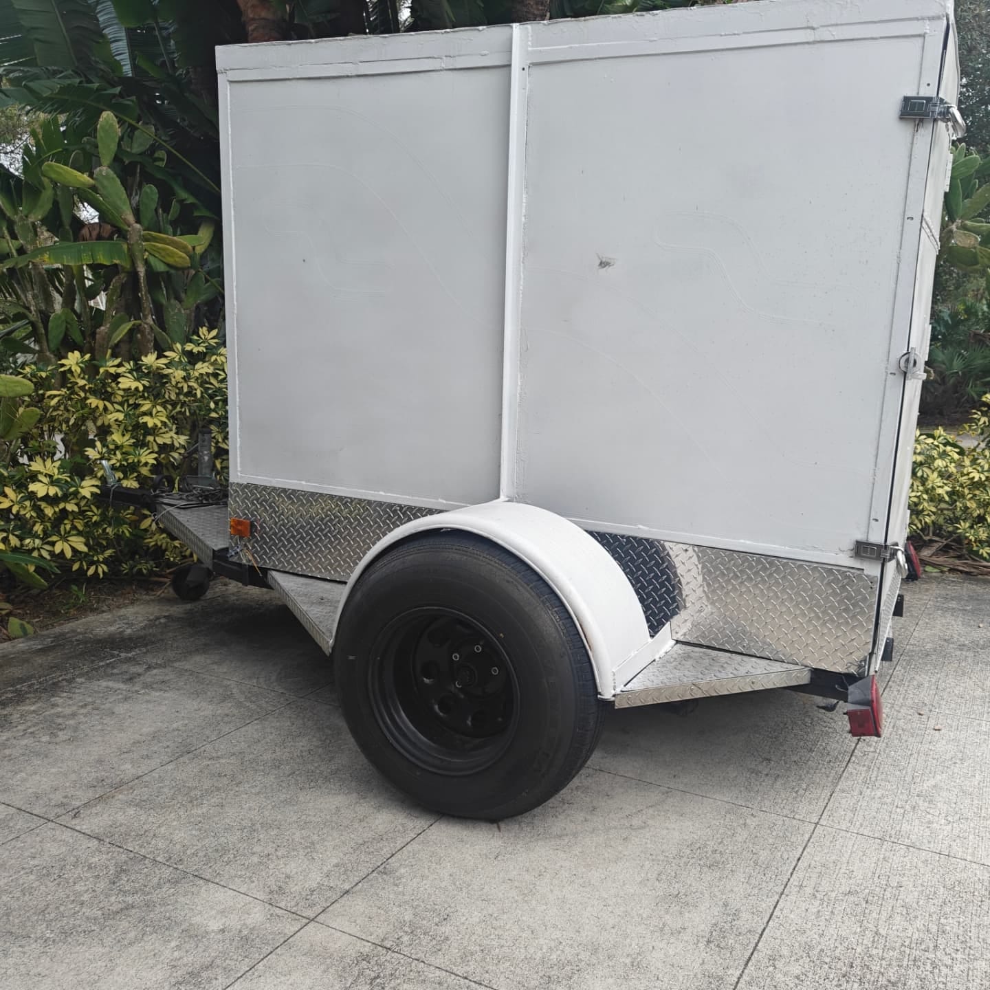 White enclosed trailer restored by Curb Appeal, rust treated and repainted